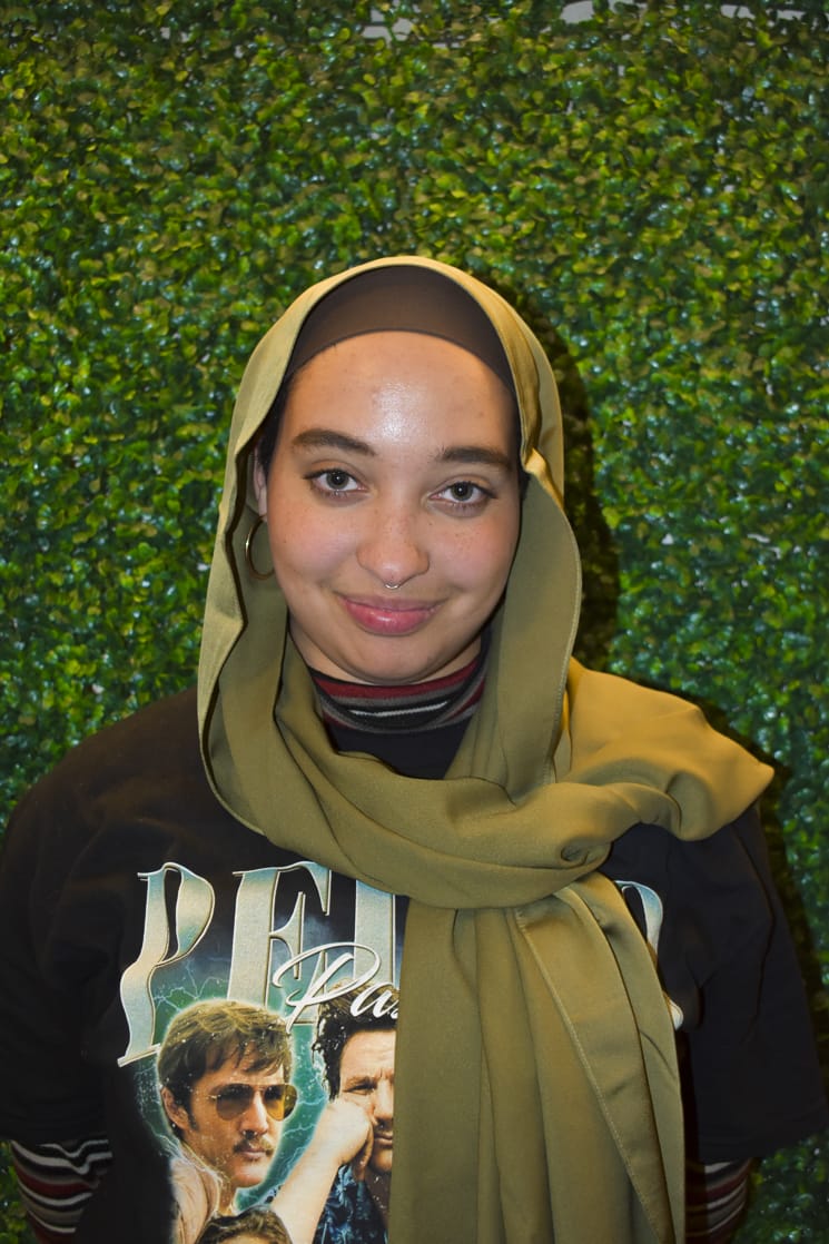 Clementia in a green headscarf and black t-shirt