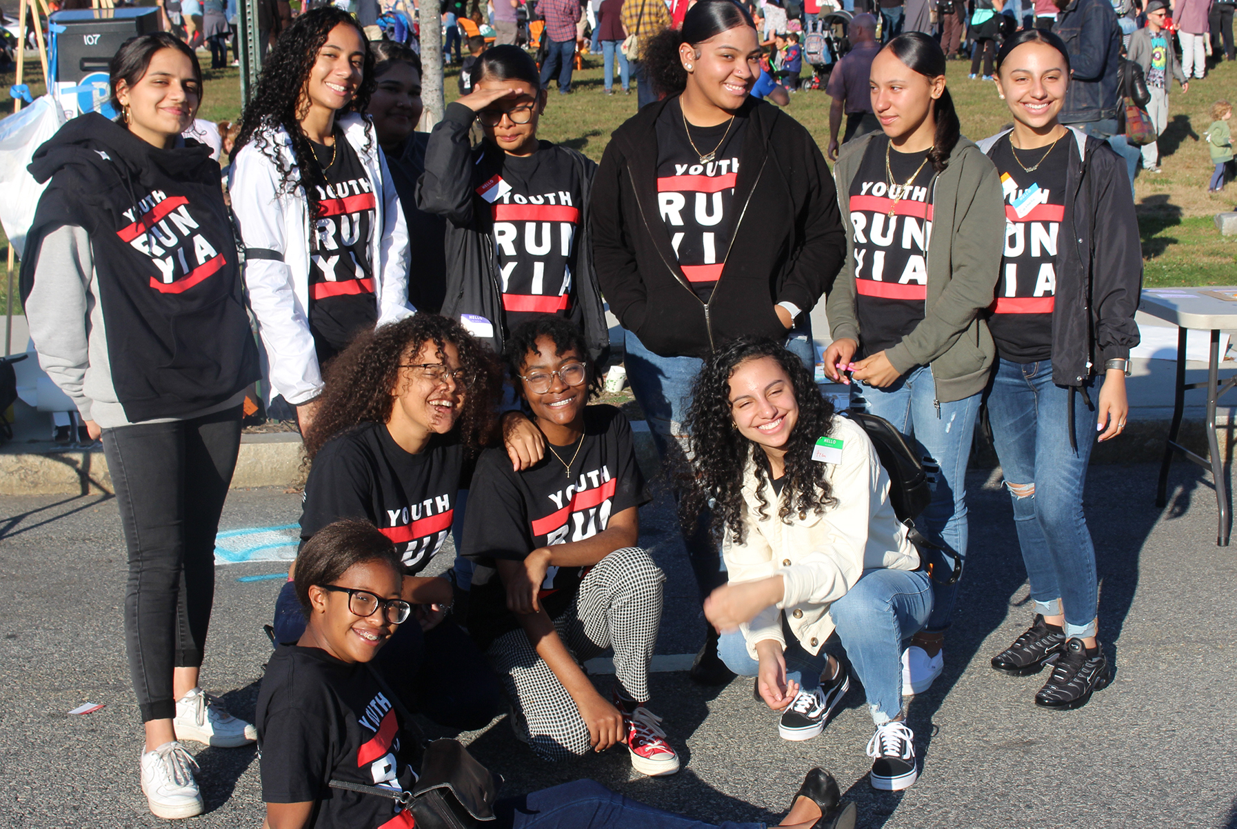 a group of young adults smiling and wearing tshirts that read "Youth Run YIA"